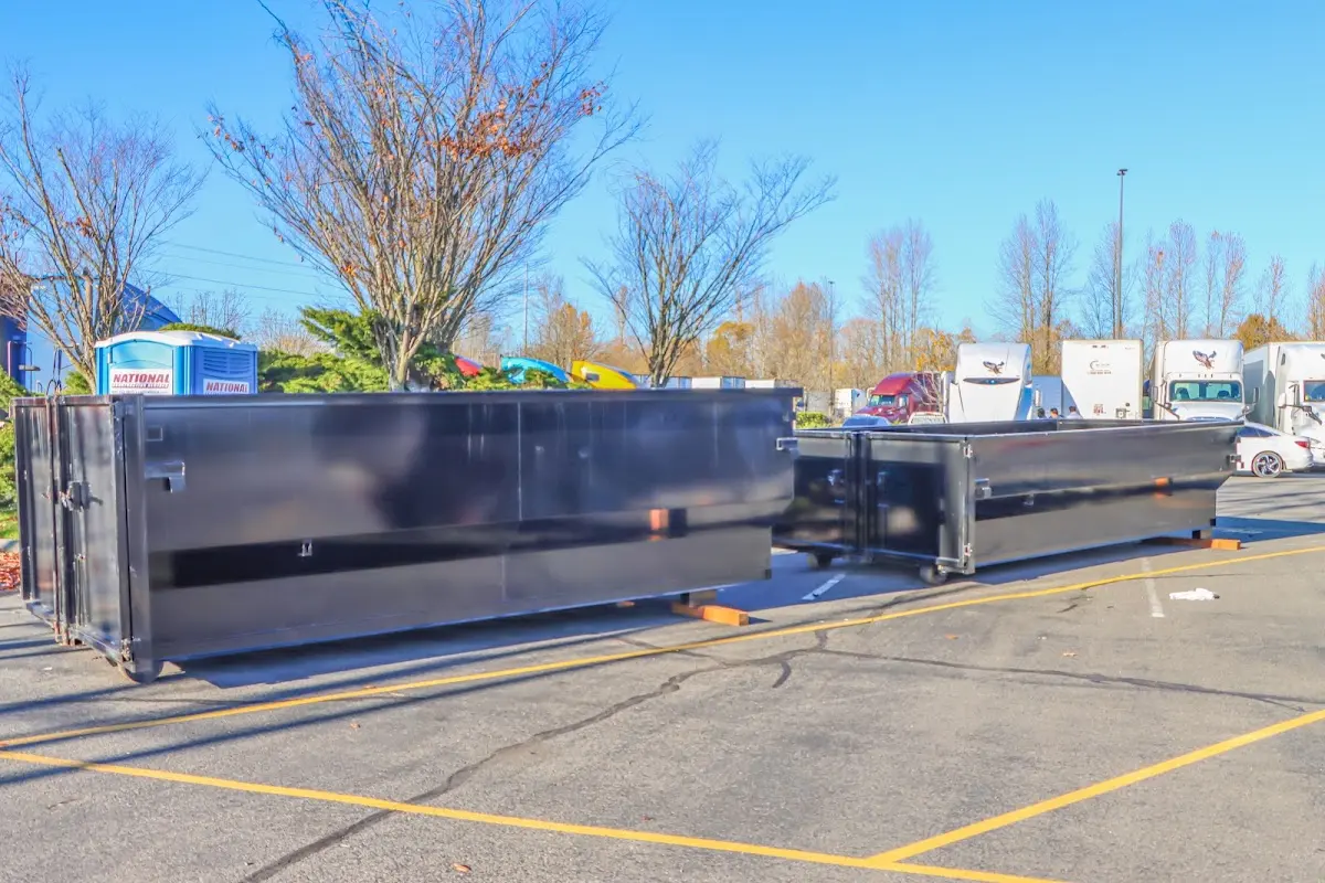 Professional dumpster rental service with roll-off container on residential driveway in El Mirage